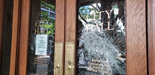 Broken windows at Portland City Hall after a recent protest.